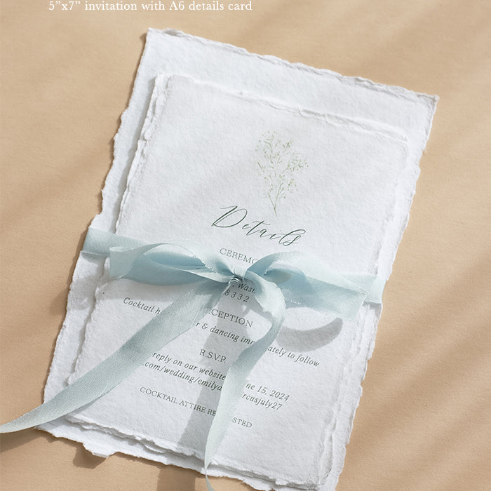 Handmade cotton rag wedding invitation with matching envelope wrapped in silk ribbon