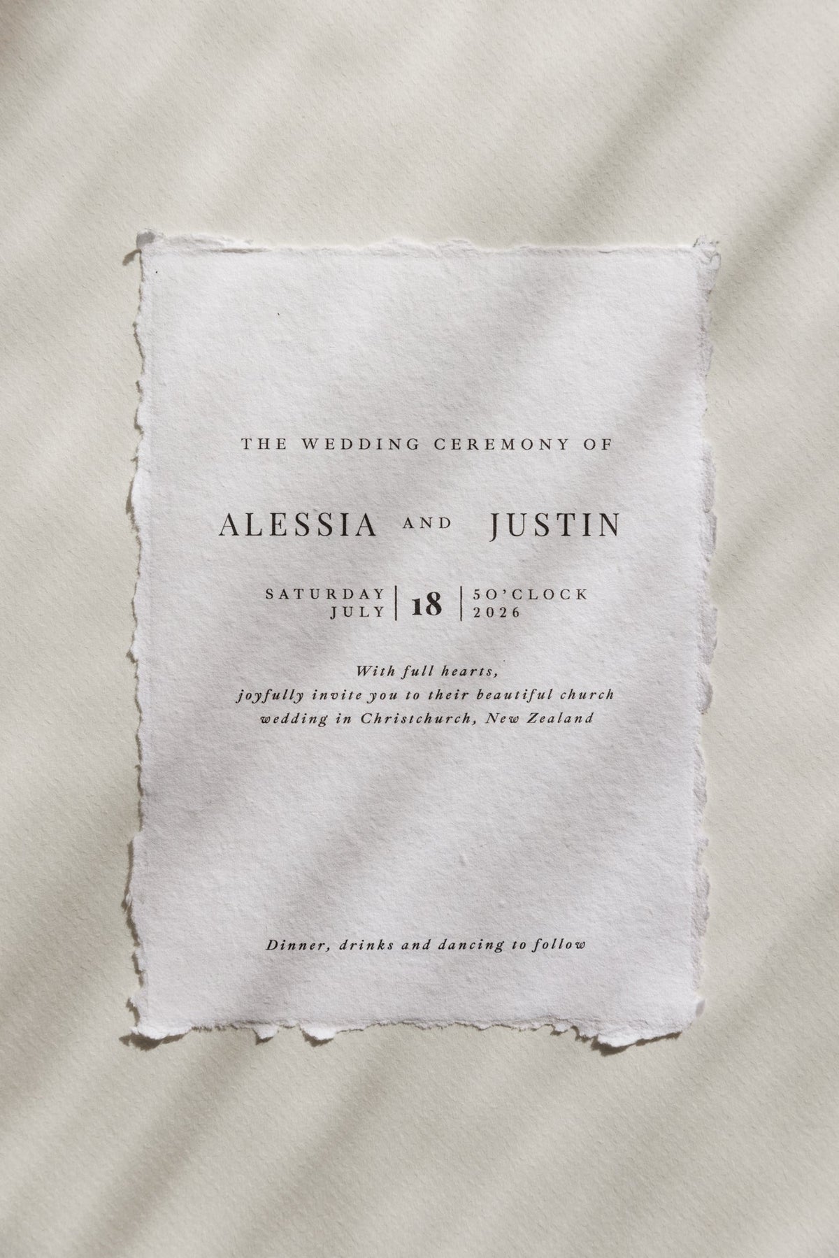 Alessia handmade paper wedding invitation with tracked serif and italic calligraphy